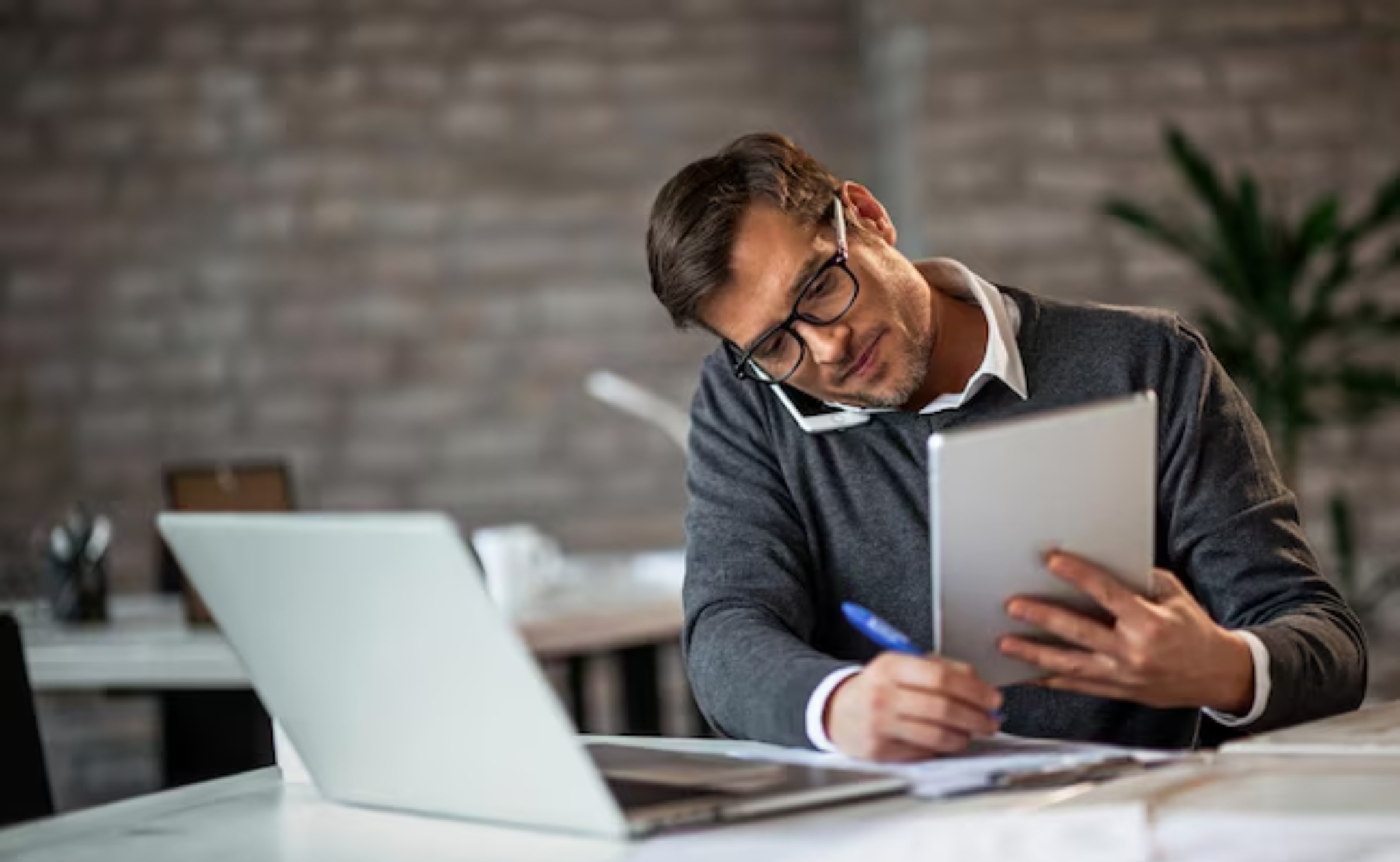 Businessman working and writing notes in office