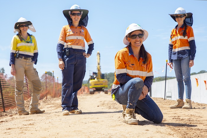 Female civil engineer discusses weir project with colleague