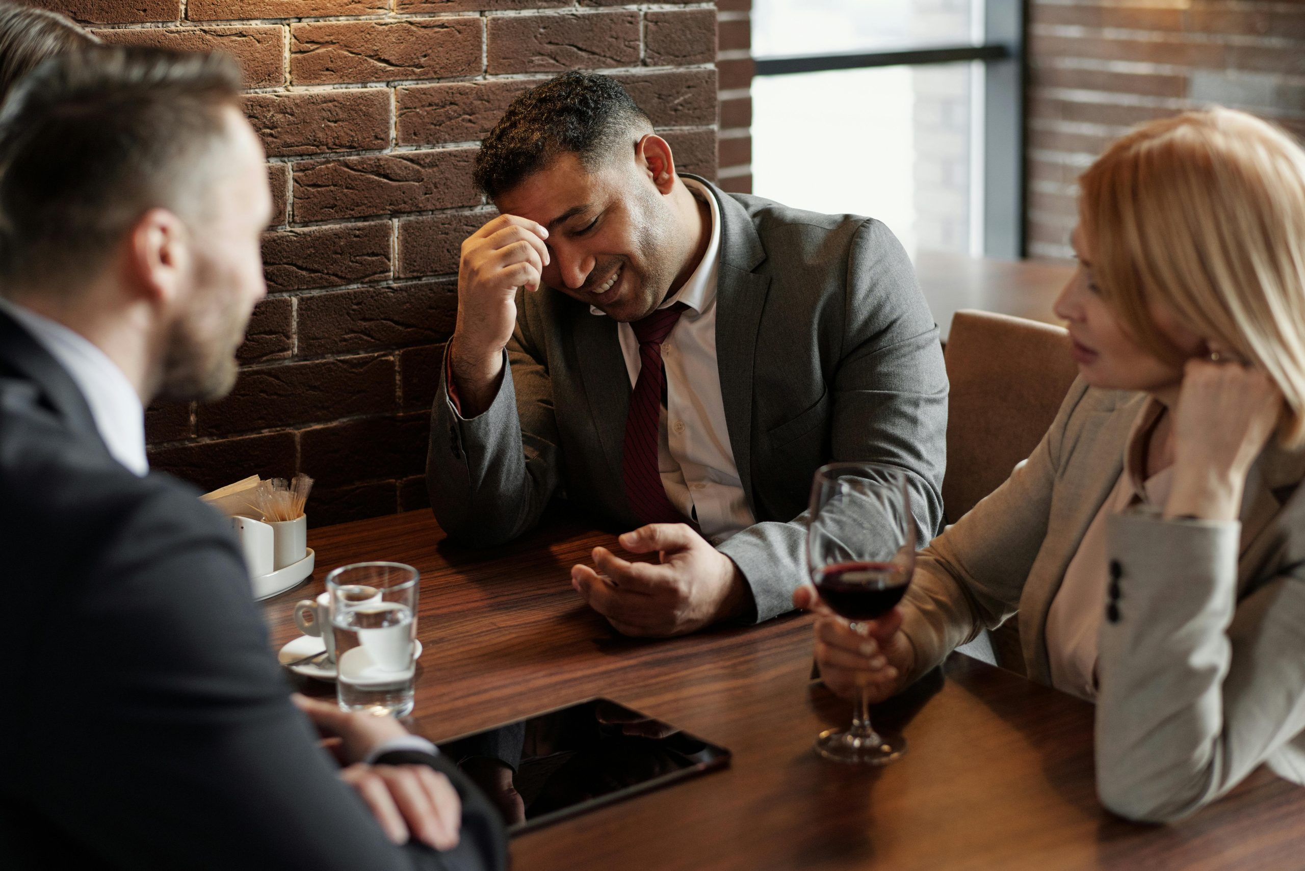 Photograph of men having conversation seating on chair