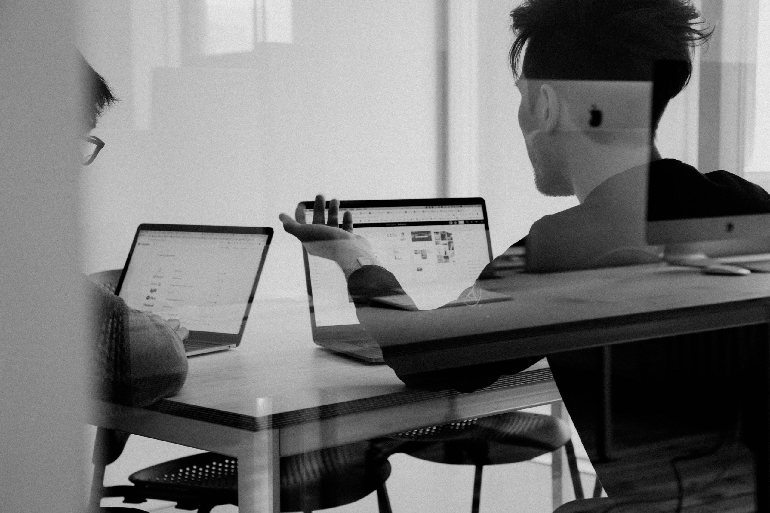 five person by table watching turned on white iMac