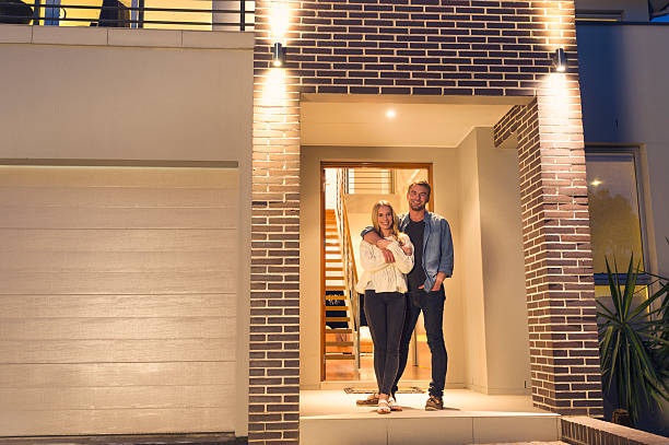 man and woman standing in front of louver door