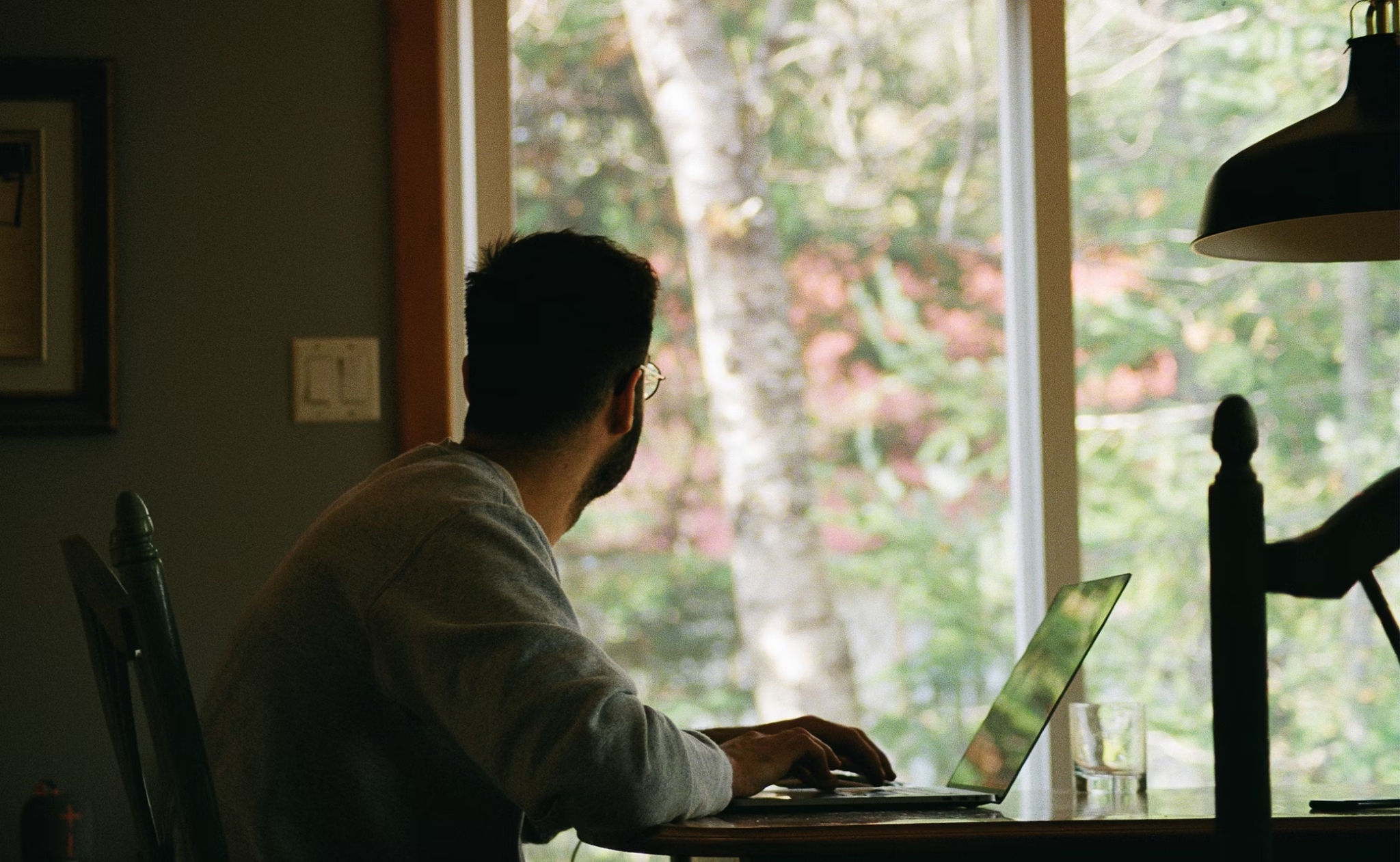 man in gray hoodie using laptop computer