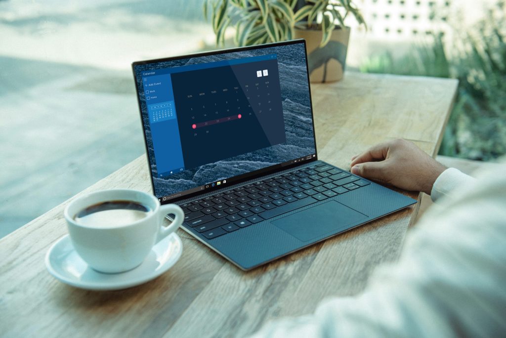 person using computer on brown wooden table