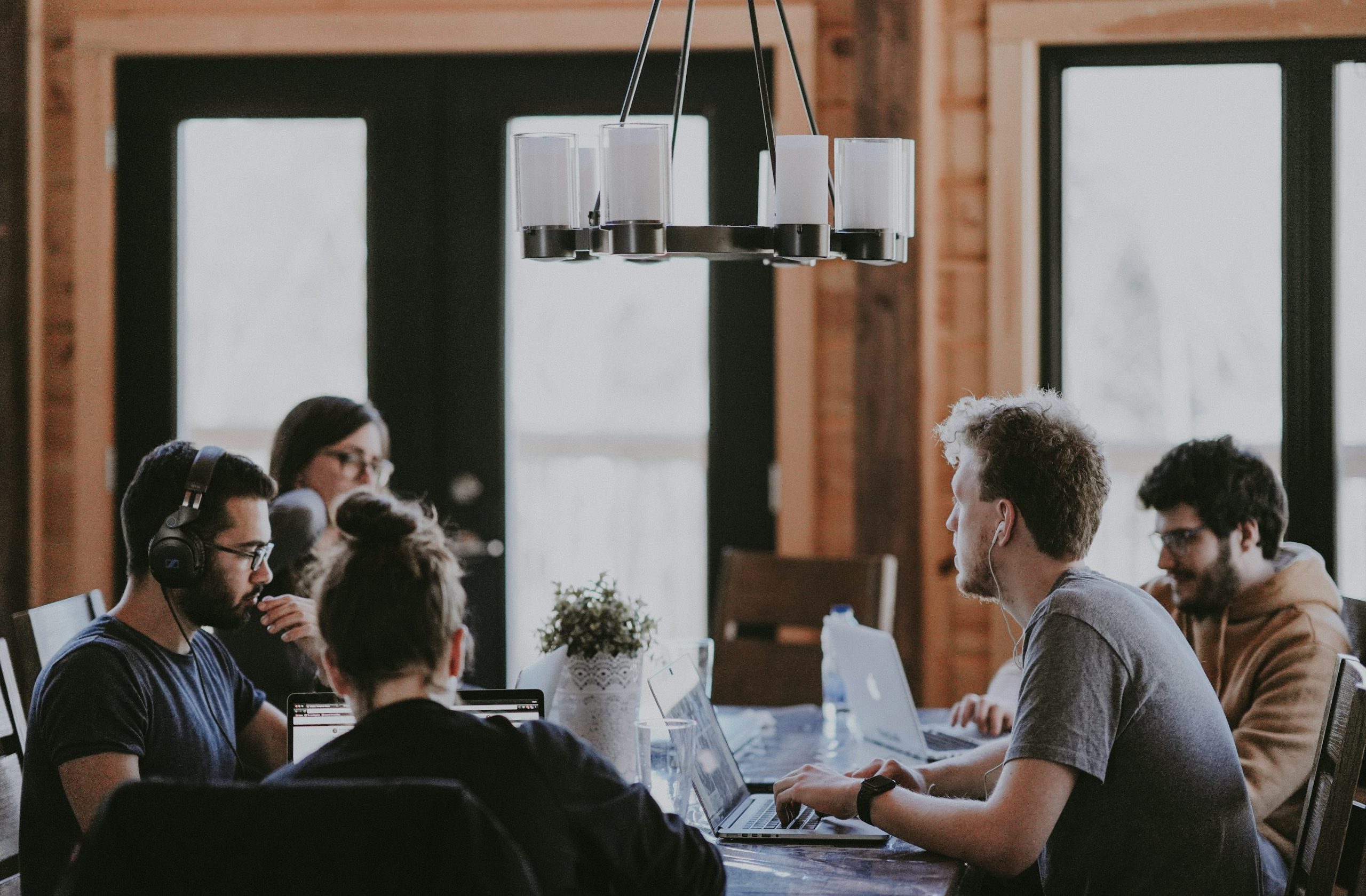 five person by table watching turned on white iMac